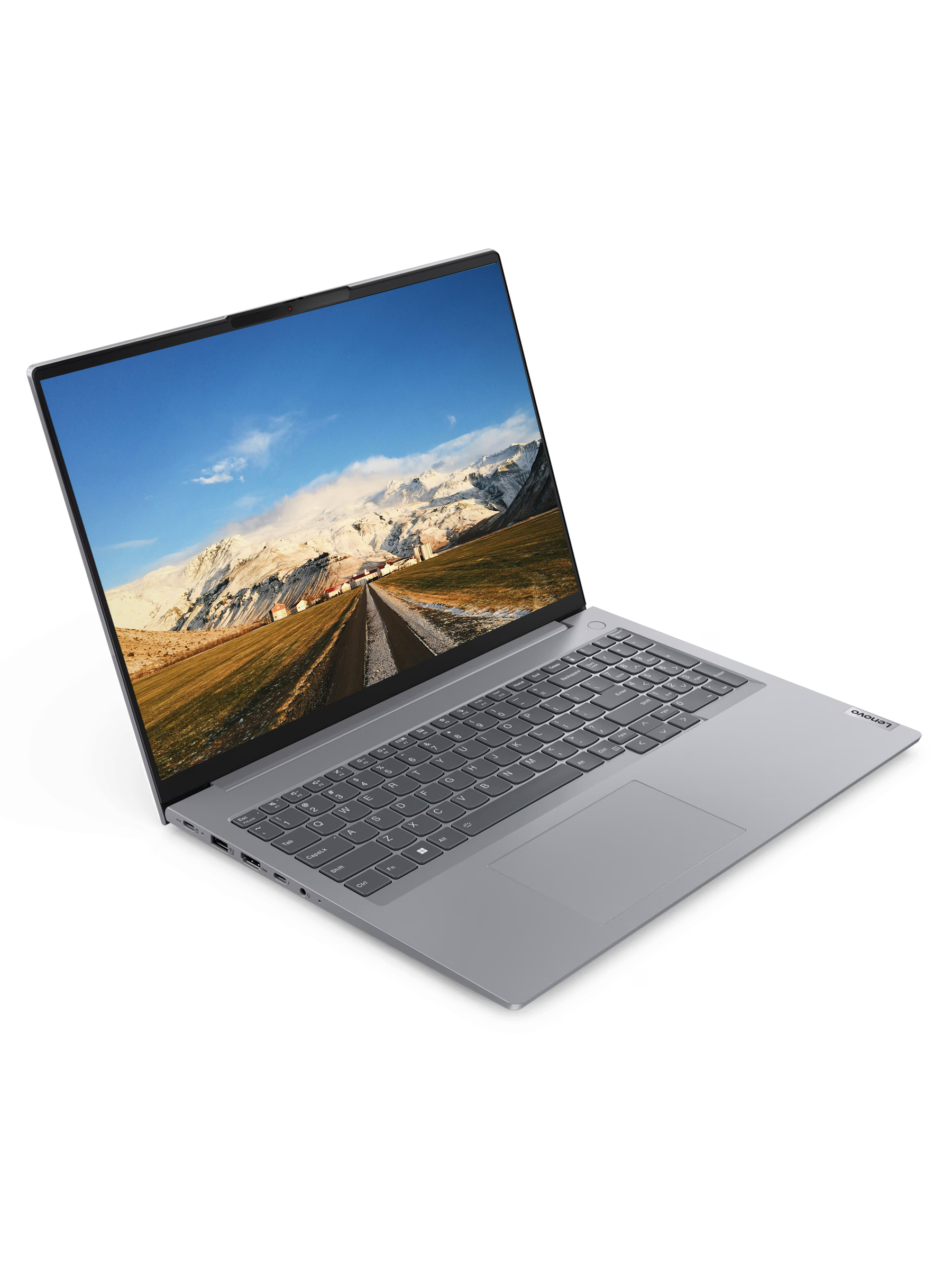 Gri bir Lenovo dizüstü bilgisayar açık, dağlar ve mavi gökyüzü ile bir yol sahnesi gösteriyor.