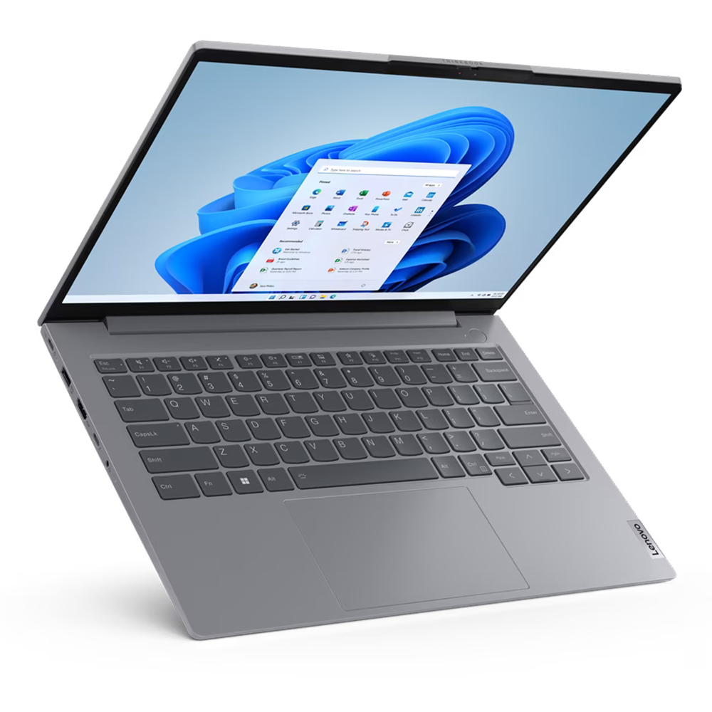 Gri bir Lenovo dizüstü bilgisayar açık, Windows 11 arayüzünü gösteriyor. Ekran, mavi bir arka plan ve uygulama simgeleri gösteriyor.