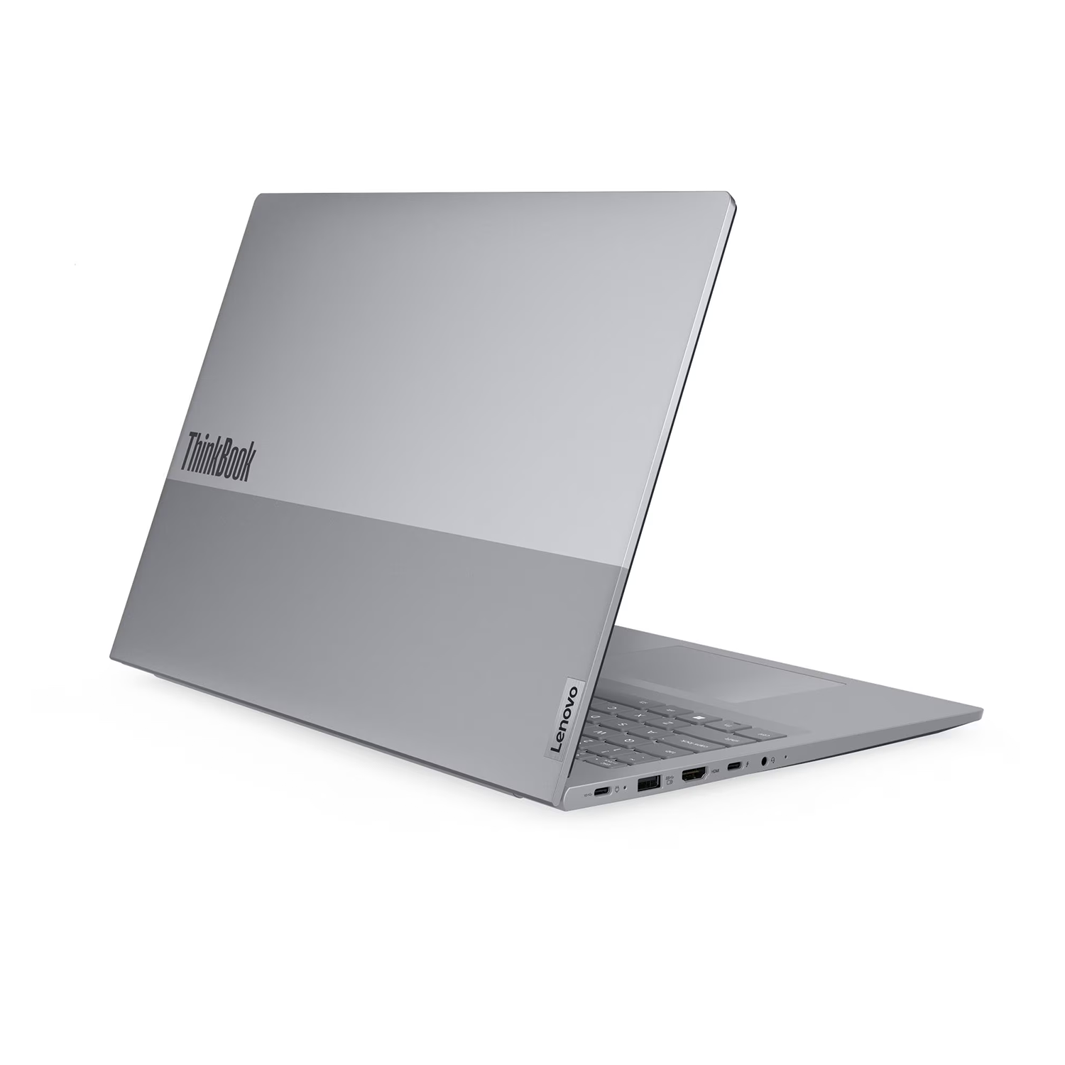 Gri bir Lenovo ThinkBook dizüstü bilgisayar hafifçe açık, klavye ve portlar görünür durumda. Arka plan beyaz.