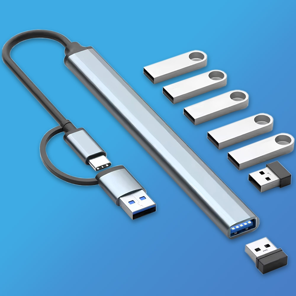 Srebrny hub USB z czarnym kablem. Na niebieskim tle znajduje się również kilka srebrnych pendrive'ów i odbiorników USB.