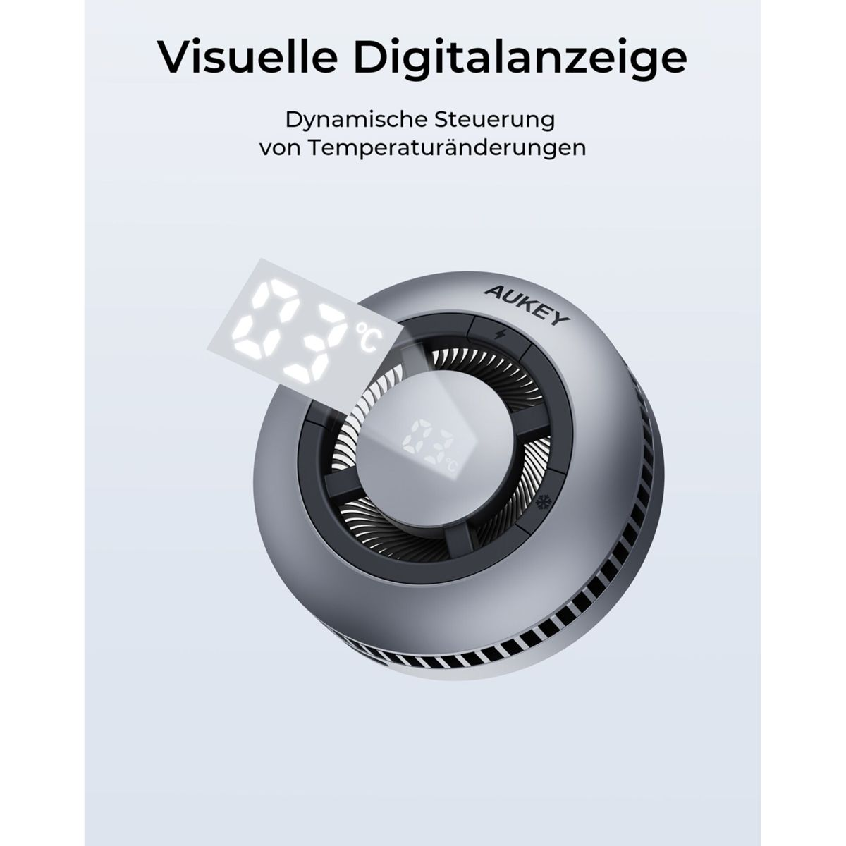 Un dispositivo plateado AUKEY con una pantalla digital que muestra 23°C. El texto superior dice: Visuelle Digitalanzeige. Control dinámico de temperatura.