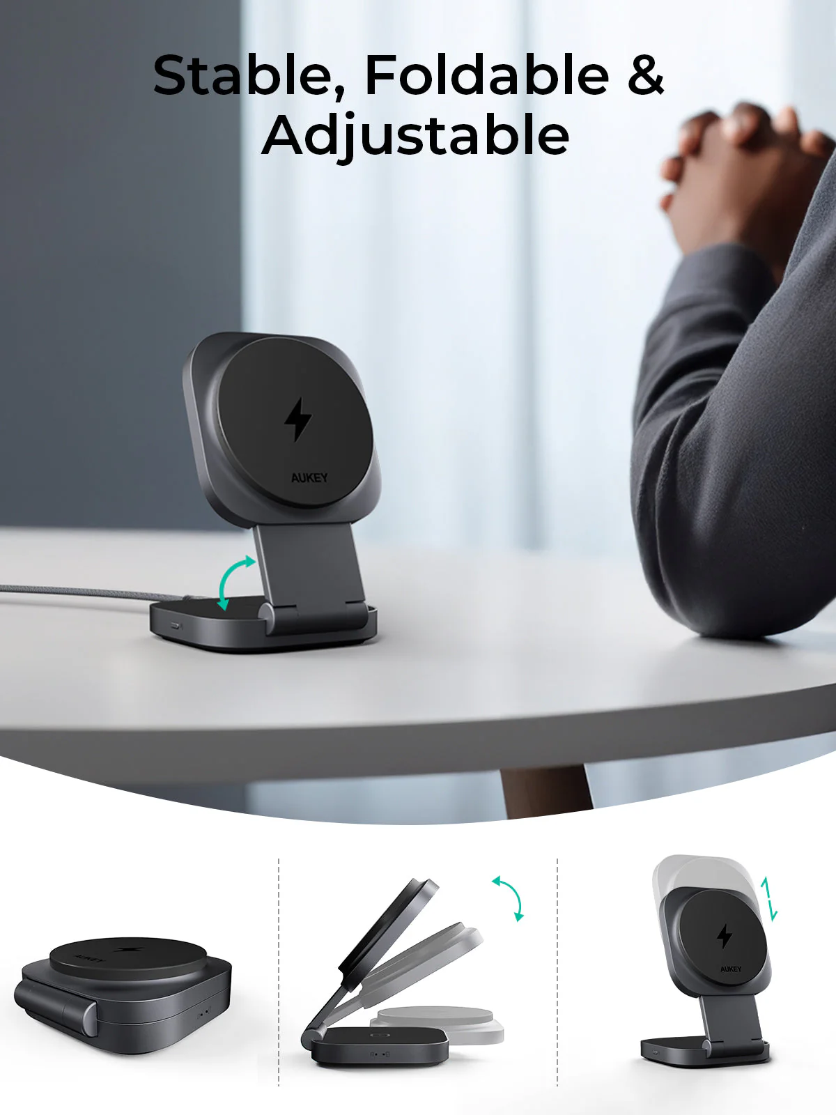 Un cargador inalámbrico AUKEY negro está sobre una mesa blanca. Es plegable y ajustable. Manos de una persona en el fondo.