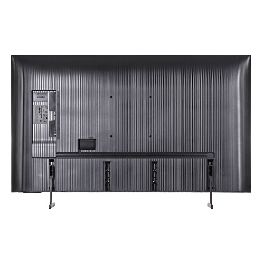 Widok z tyłu dużego, ciemnoszarego telewizora. Teksturowany tył z podstawą i widocznymi portami.