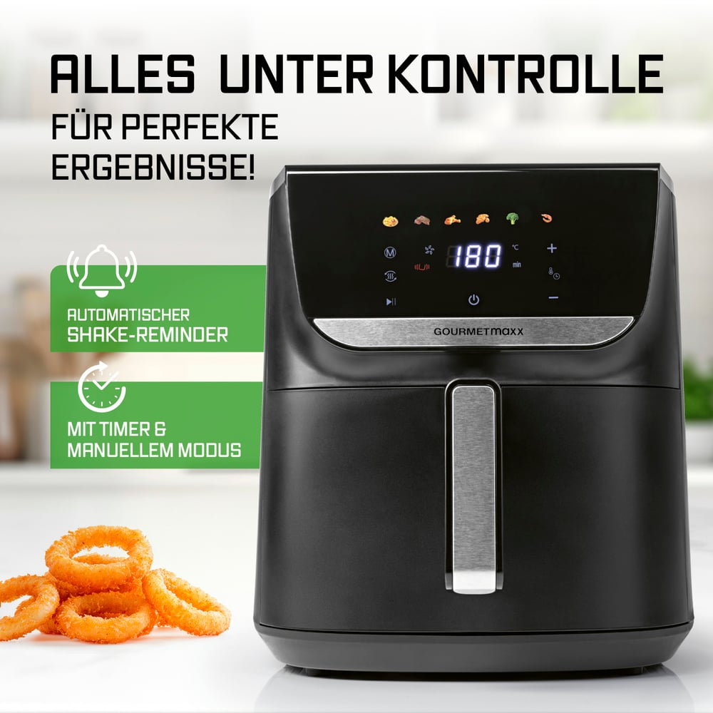 Schwarze Heißluftfritteuse mit Digitalanzeige, die 180 Grad anzeigt. Zwiebelringe im Vordergrund und Text auf Deutsch links oben.