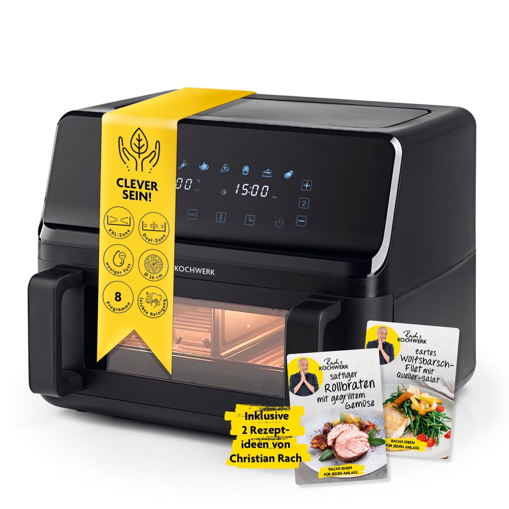 Ein schwarzer Airfryer mit gelbem Band. Rezeptkarten liegen davor. Das Display zeigt die Zeit. Der Fryer hat Knöpfe und ein Glasfenster.