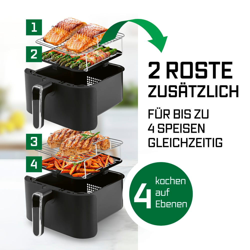 Eine Heißluftfritteuse mit zwei Rosten. Zeigt Lachs, Spargel, Hähnchen und Süßkartoffeln. Text: 2 zusätzliche Roste für bis zu 4 Gerichte gleichzeitig.