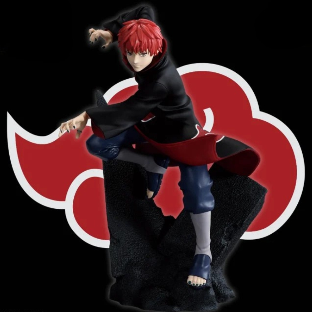 Una statuetta di un personaggio con capelli rossi, abito nero e mantello rosso. È in posa da combattimento su una base di pietra nera, con logo a nuvola rossa.