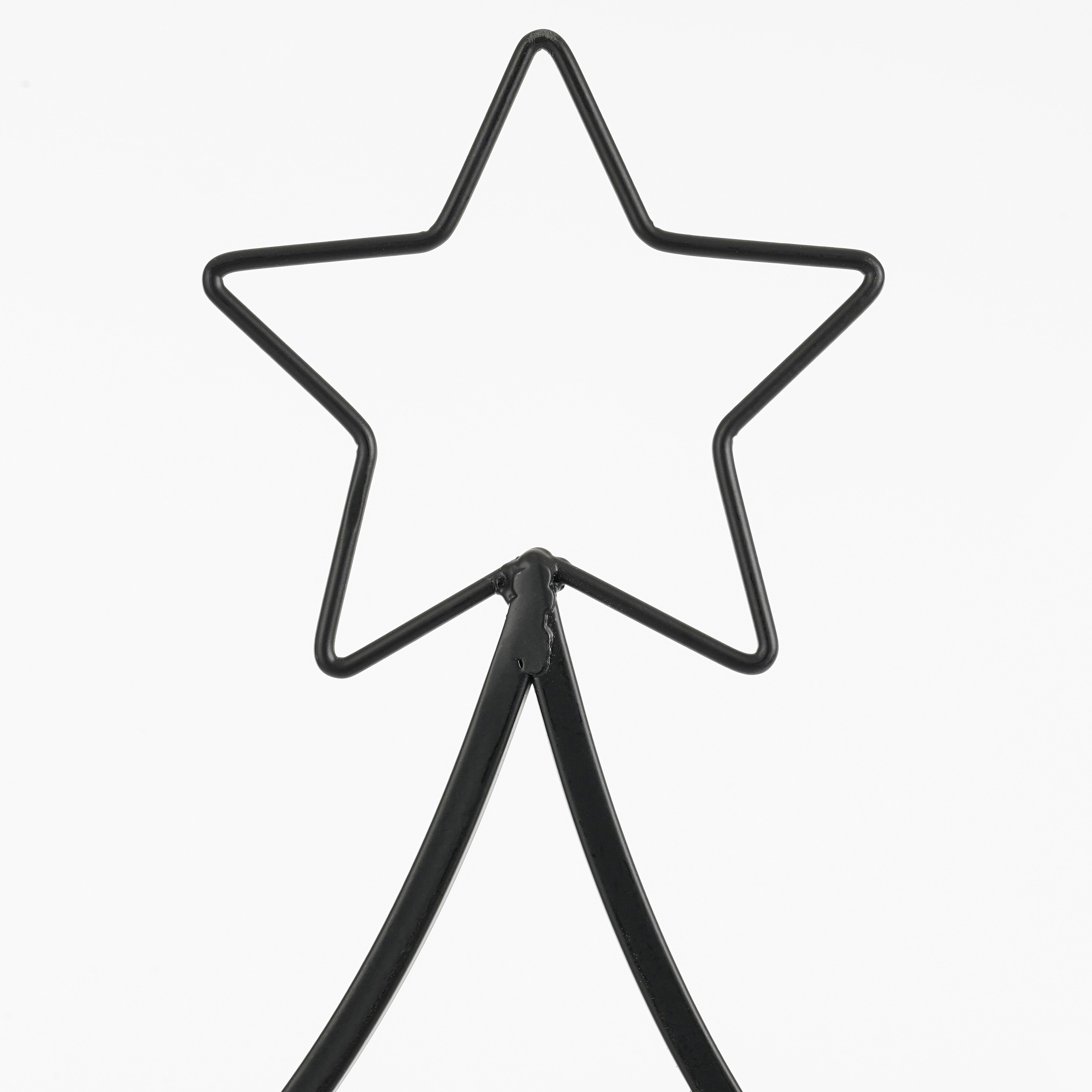 Décoration en étoile en métal noir sur fond blanc. L'étoile est un cadre, soutenu par un support.