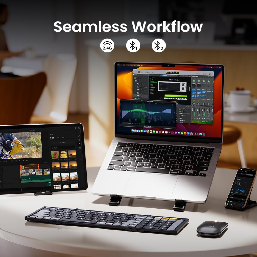 A laptop, tablet, and phone are on a desk with a keyboard and mouse. The laptop screen displays a music editing software.
