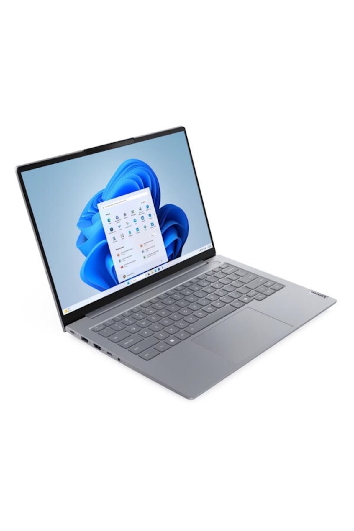 Gri bir Lenovo dizüstü bilgisayar, uygulama simgeleriyle bir Windows 11 masaüstü gösteriyor. Ekran mavi soyut bir tasarım gösteriyor.