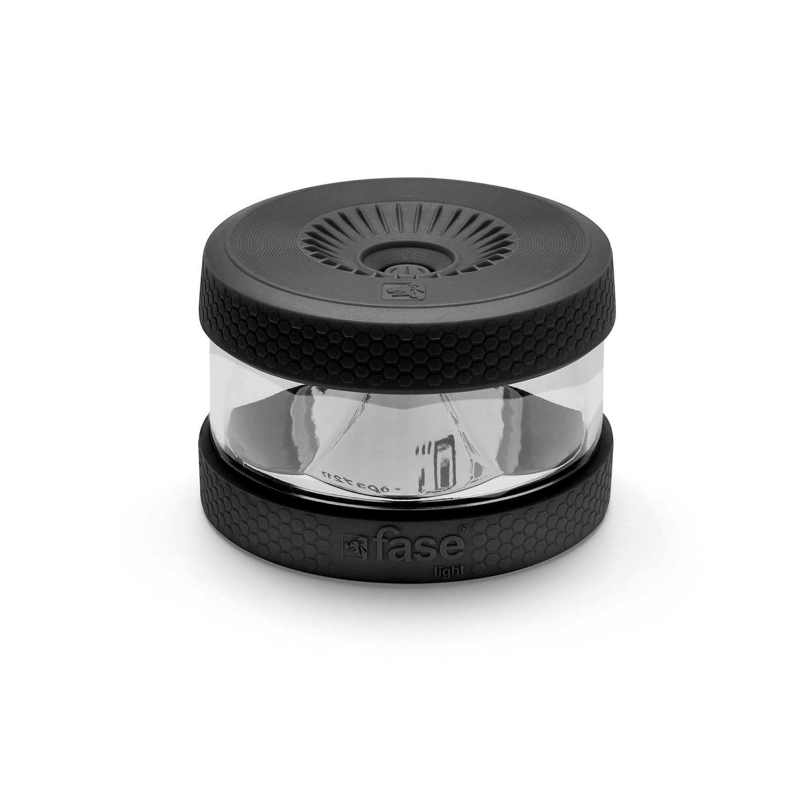 Luz Fase negra y transparente. Tiene un patrón hexagonal en la base y la parte superior. La parte superior tiene un diseño circular.