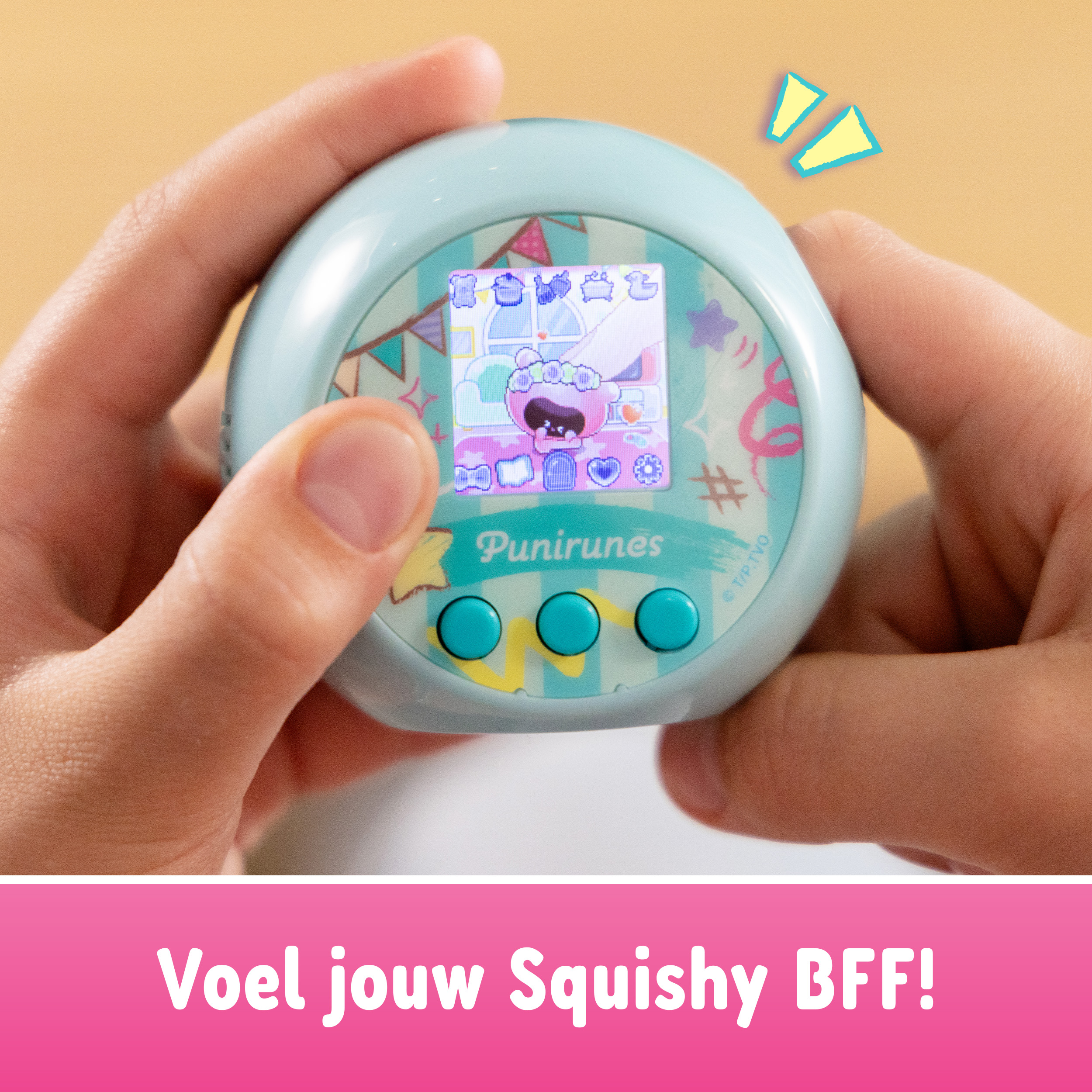 Osoba trzyma turkusową zabawkę z ekranem cyfrowym. Wyświetla różową istotę. Tekst mówi: 'Poczuj swojego Squishy BFF!'