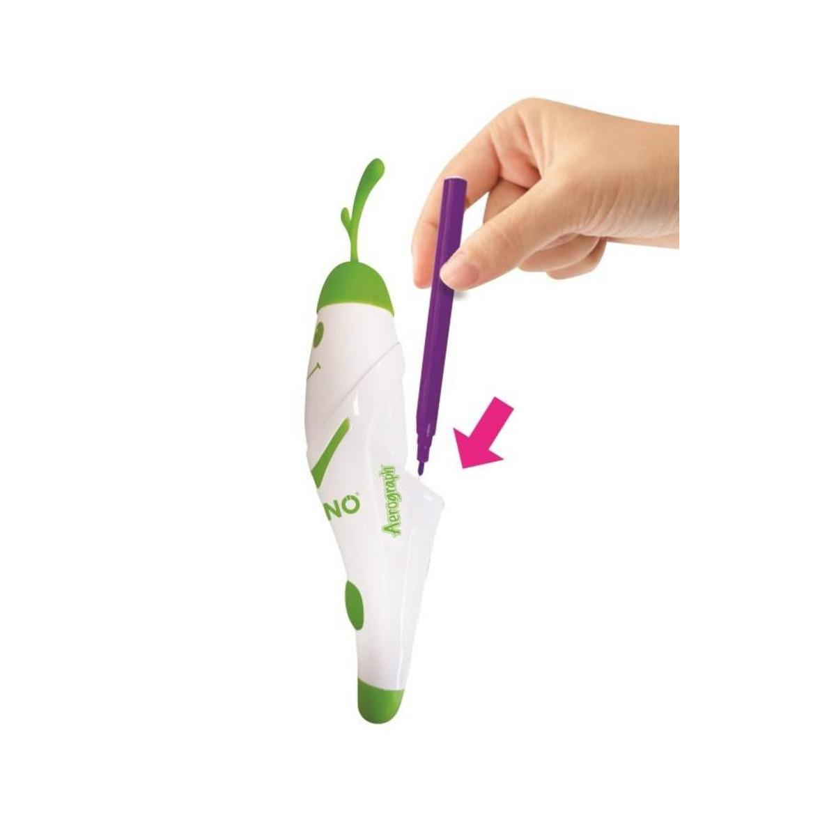Una mano sostiene un bolígrafo morado sobre un dispositivo blanco y verde. Una flecha rosa apunta hacia abajo. El dispositivo dice 'Aerograph' y 'NO'.