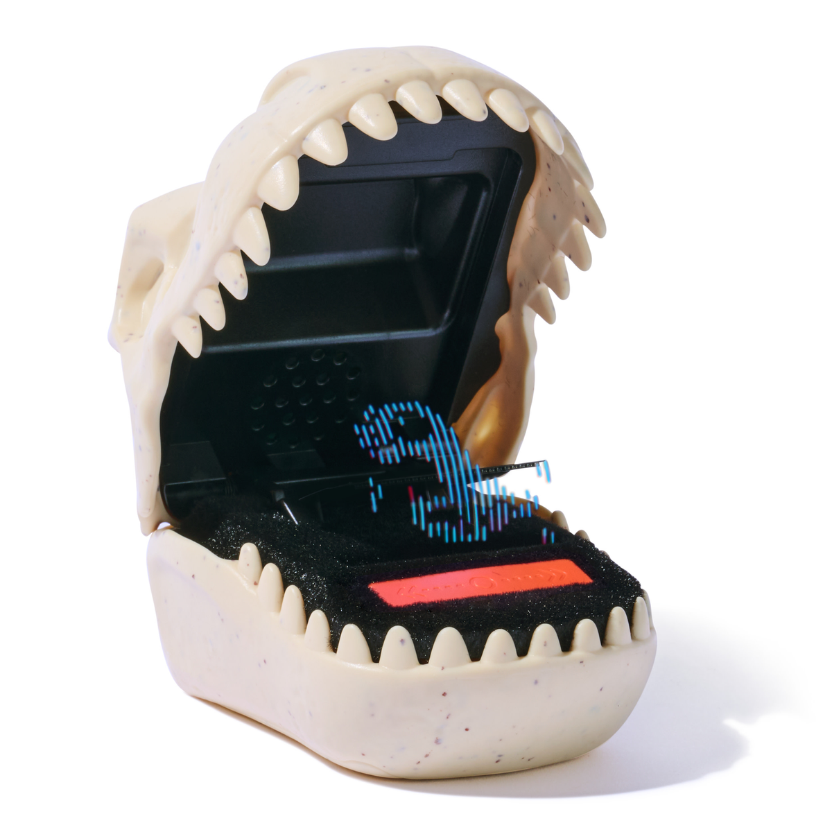Un juguete con forma de cráneo de dinosaurio, abierto para revelar un interior negro con una imagen digital de dinosaurio y una pantalla rectangular roja.
