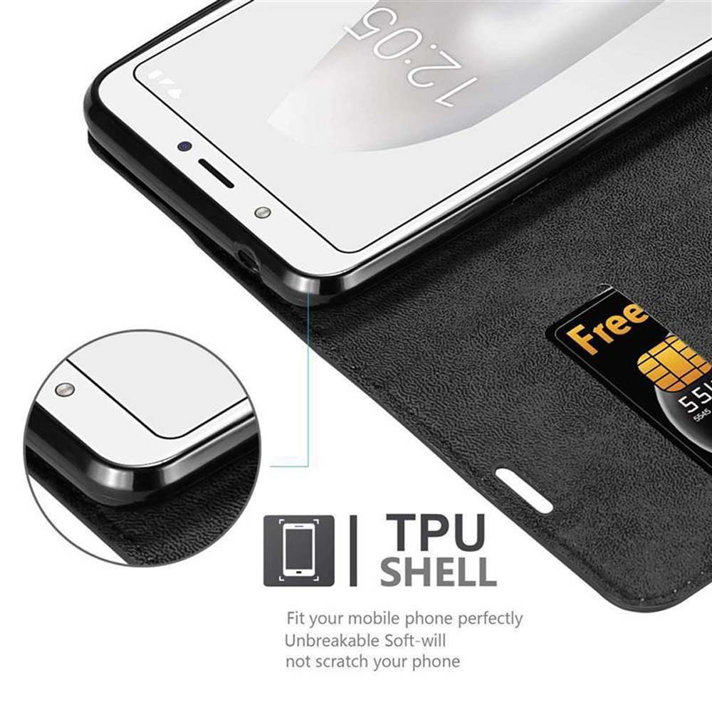 Un telefono in una custodia nera, con una carta 'Free'. Lo schermo mostra 12:05. Etichetta TPU SHELL visibile.