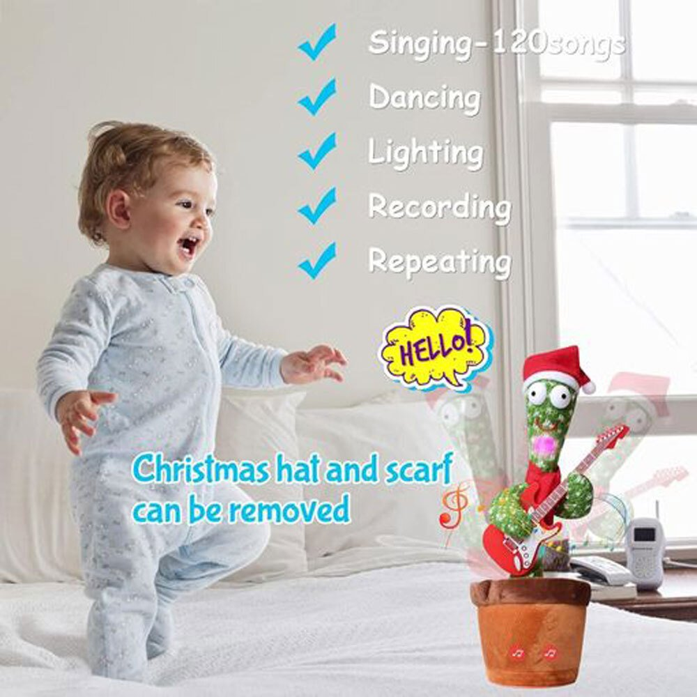Un bebé y un juguete de cactus están en una cama. El cactus lleva un gorro de Papá Noel y tiene una guitarra. El texto dice '¡Hola!'