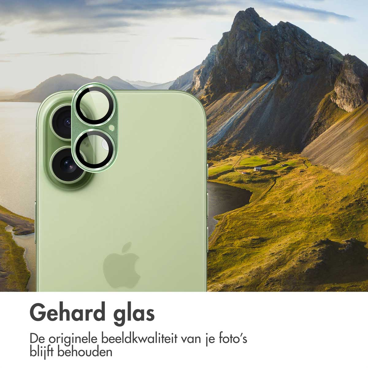 A green iPhone with lens covers is in focus. In the background, there's a mountain landscape with a lake.