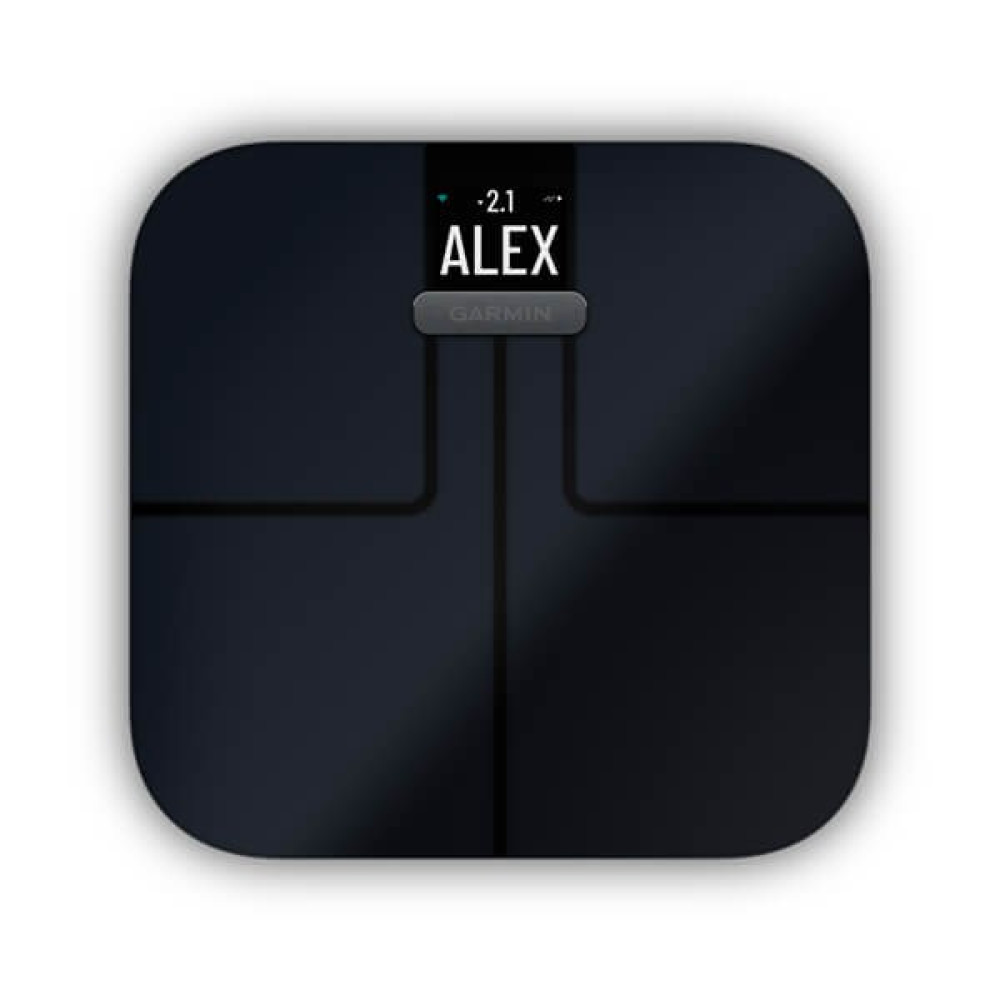 Bilancia digitale nera con la scritta "-2.1" e "ALEX". Un pulsante Garmin è sotto lo schermo. La bilancia è su una superficie bianca.
