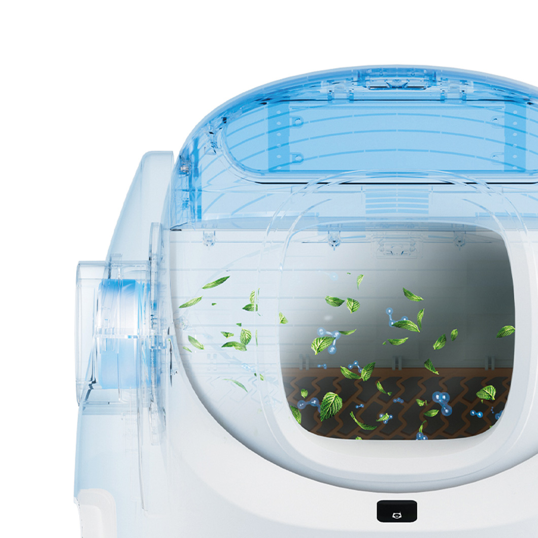 A white and blue cat litter box with a transparent top, showing leaves and atom-like structures inside, with a black button at the bottom.