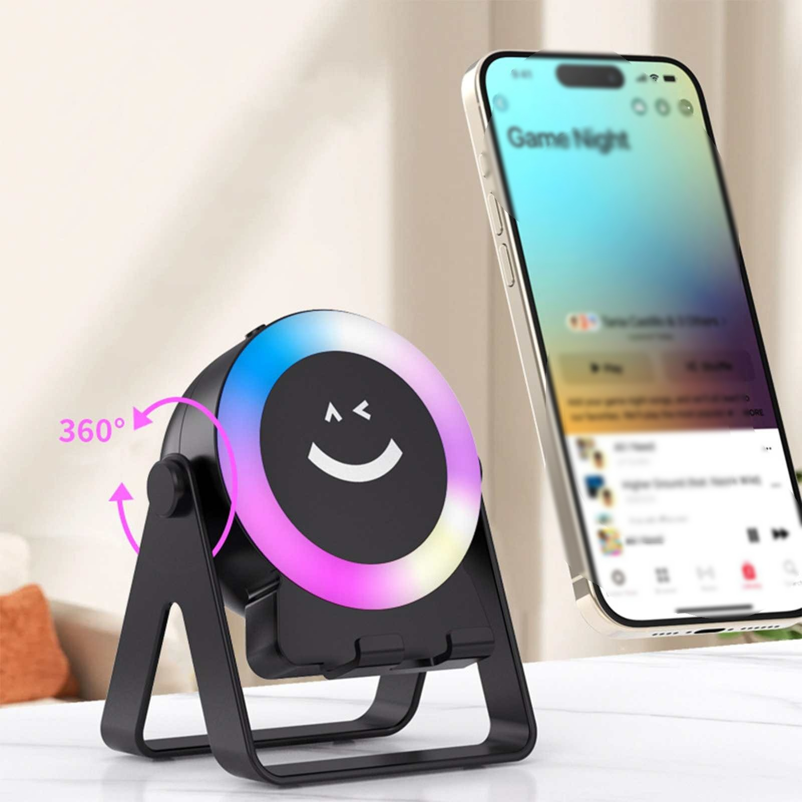 Ein schwarzer Telefonständer mit einem Smiley-Gesicht-Licht. Daneben befindet sich ein Telefon, das eine Musik-App anzeigt.