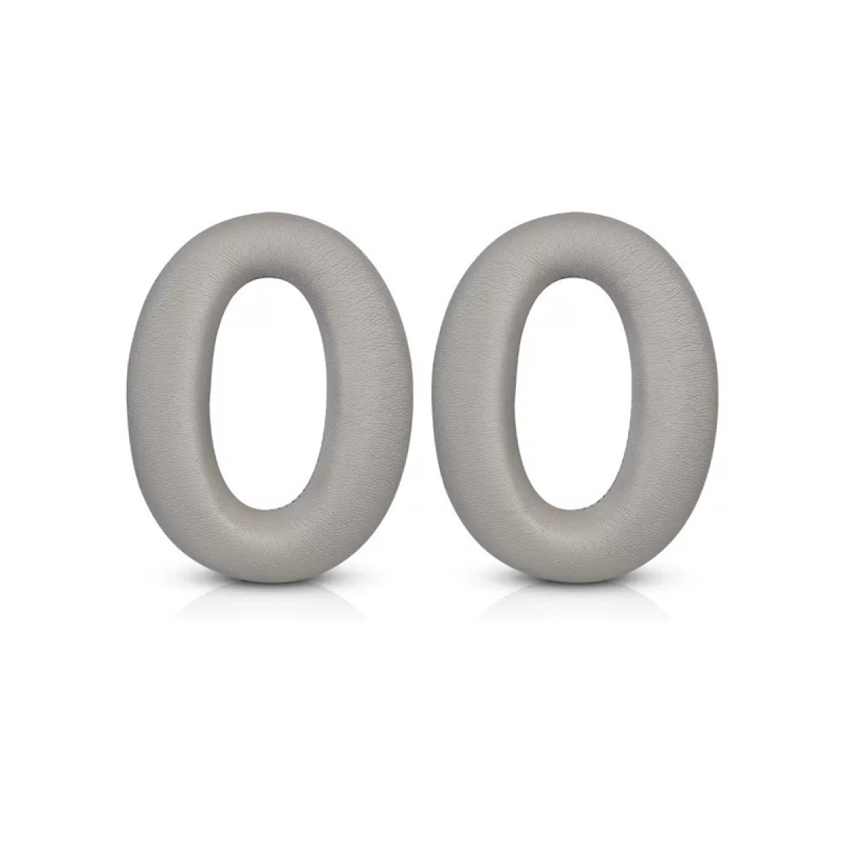 Due cuscinetti auricolari grigi ovali su sfondo bianco. Sembrano essere per cuffie.