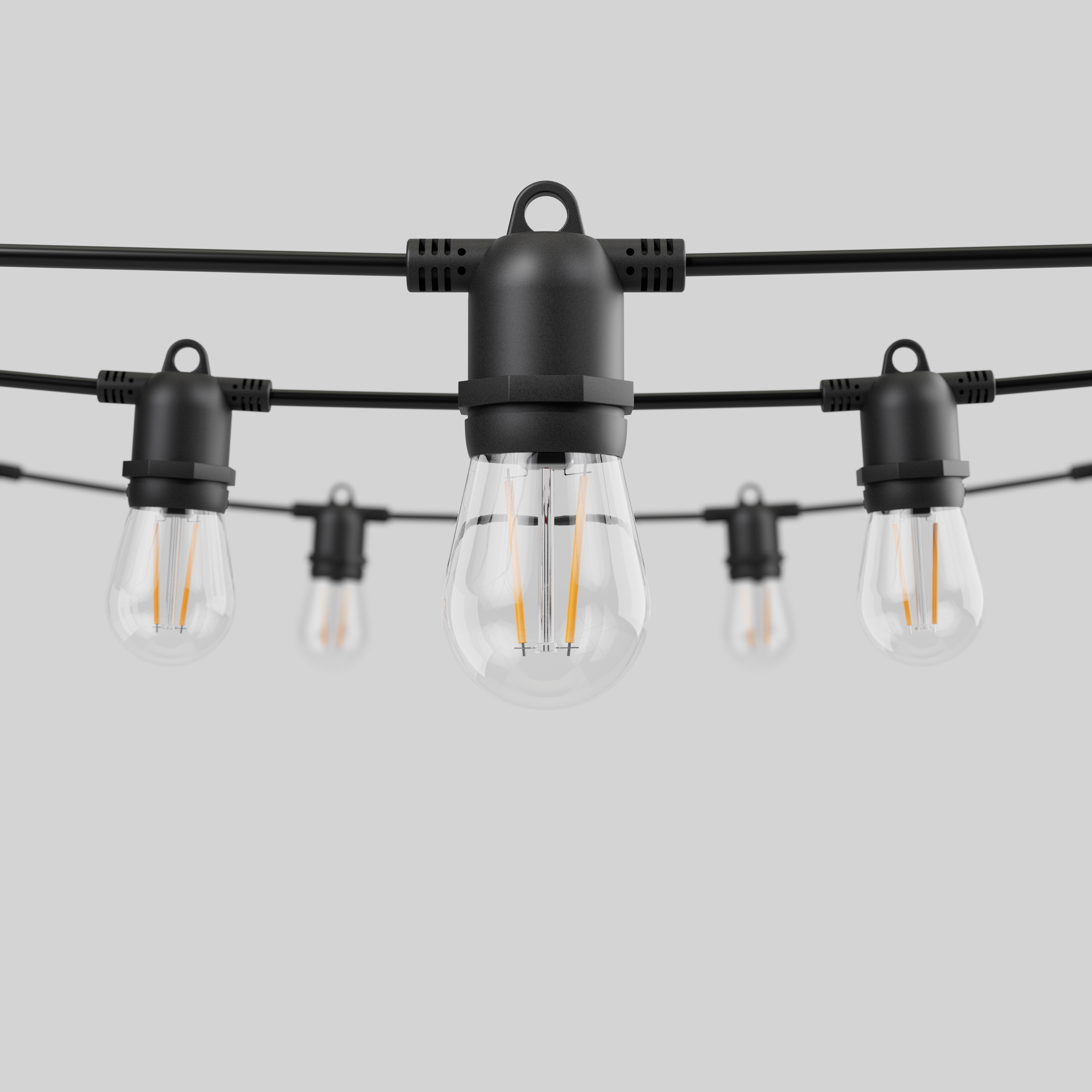 String lights with teardrop bulbs. Black cords and bulb holders against a white background. Bulbs are clear.