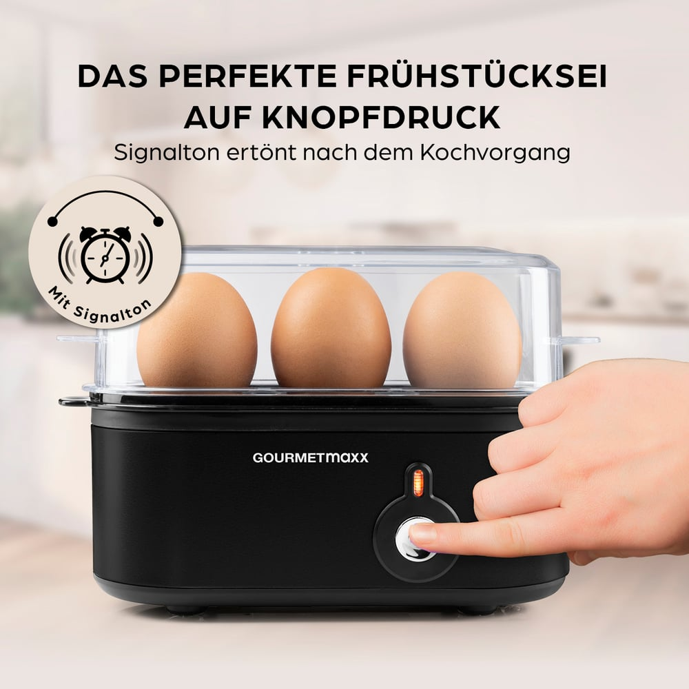 Ein Eierkocher mit drei Eiern. Eine Hand drückt den Knopf. Text sagt: 'Perfektes Frühstücksei auf Knopfdruck'.