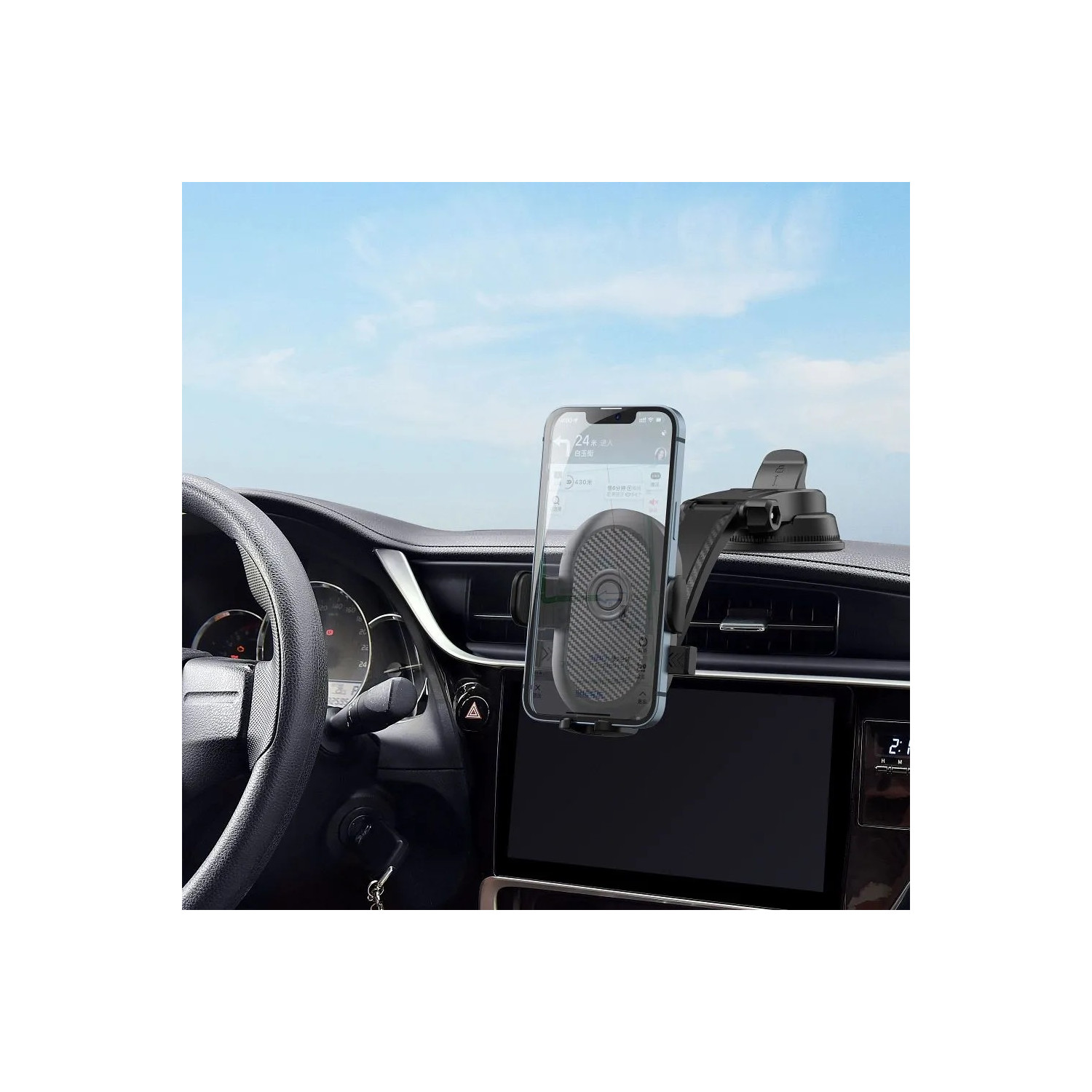 Un telefono in un supporto per auto sul cruscotto di un'auto. Il telefono mostra un'app di navigazione, volante a sinistra, cielo blu sullo sfondo.