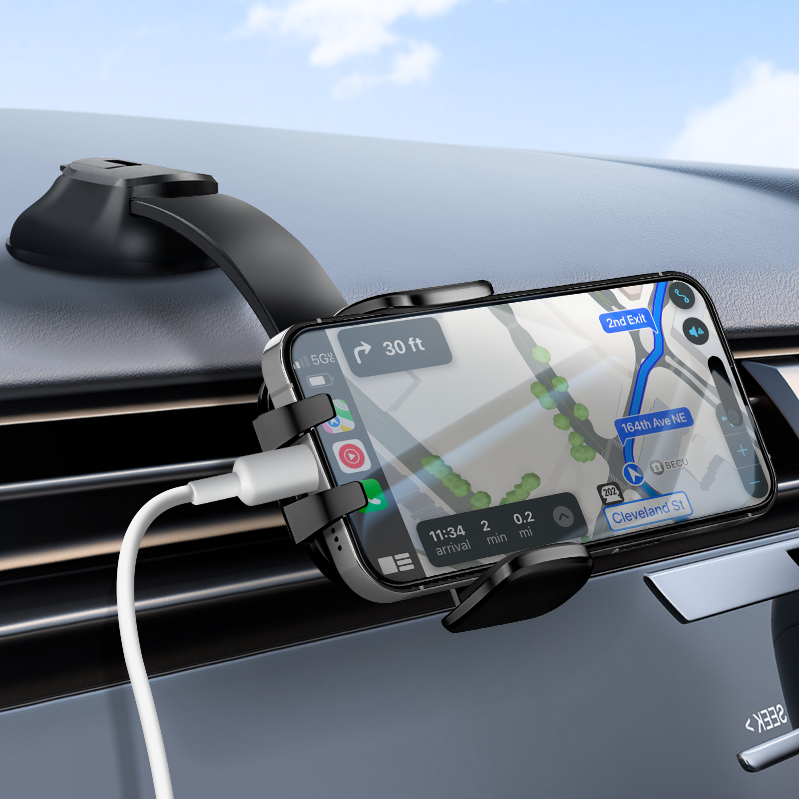Un telefono in un supporto per auto mostra un'app di navigazione. Un cavo bianco è collegato. Il cielo è visibile sullo sfondo.