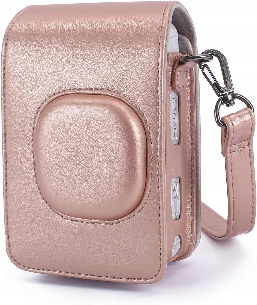 Różowo-złote etui na aparat z paskiem. Etui ma zaokrąglony przód i przyciski z boku. Srebrne zapięcie mocuje pasek.