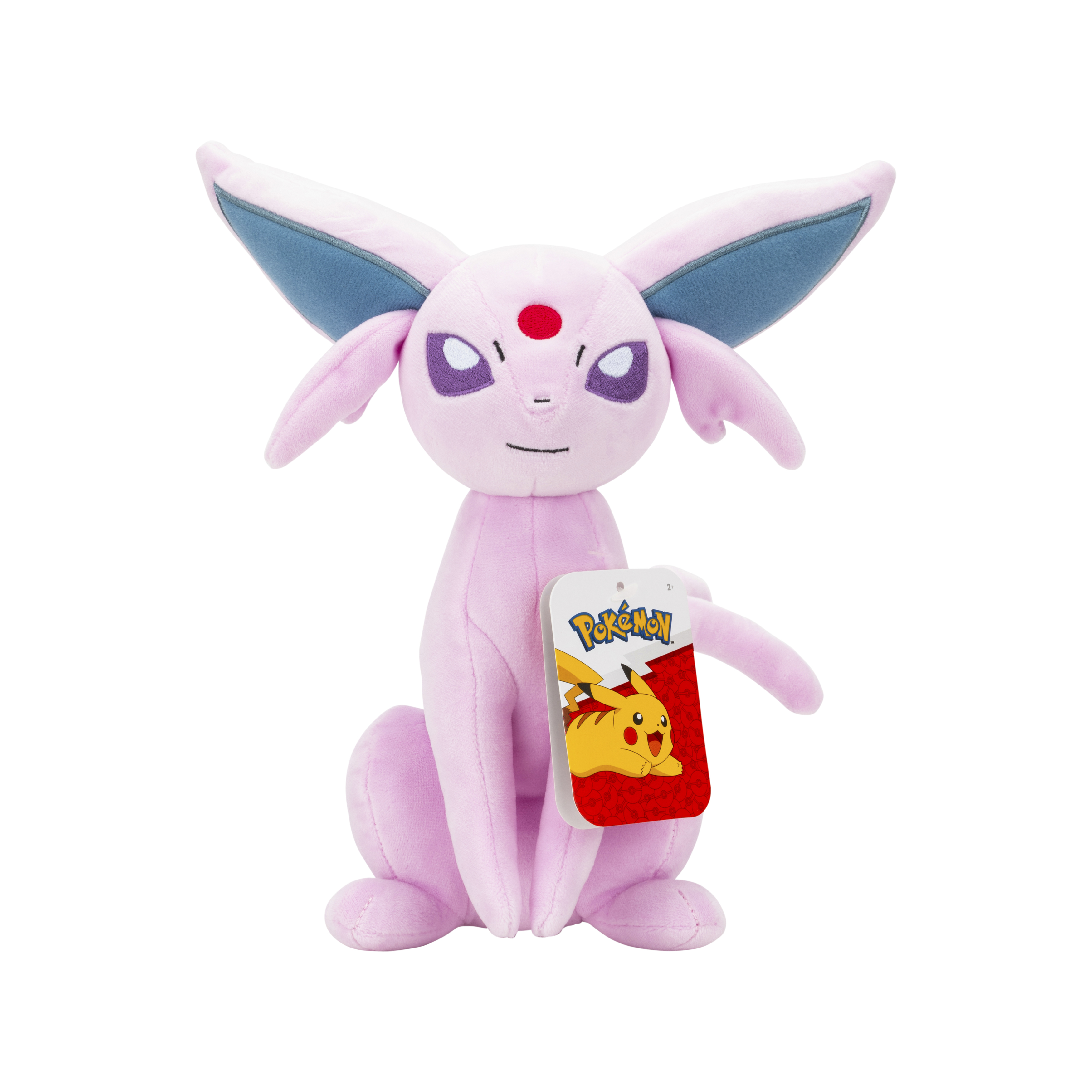 Un peluche di Espeon rosa con occhi viola, una gemma rossa e un'etichetta Pokémon. Su sfondo bianco.