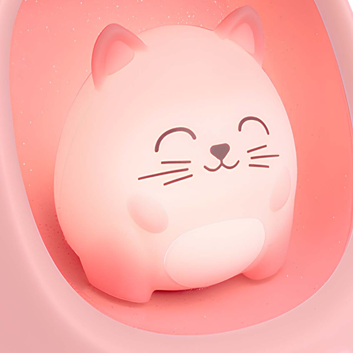 Ein rosa katzenförmiges Nachtlicht. Es hat ein lächelndes Gesicht, Schnurrhaare und Ohren. Der Hintergrund ist eine rosa, abgerundete Form.
