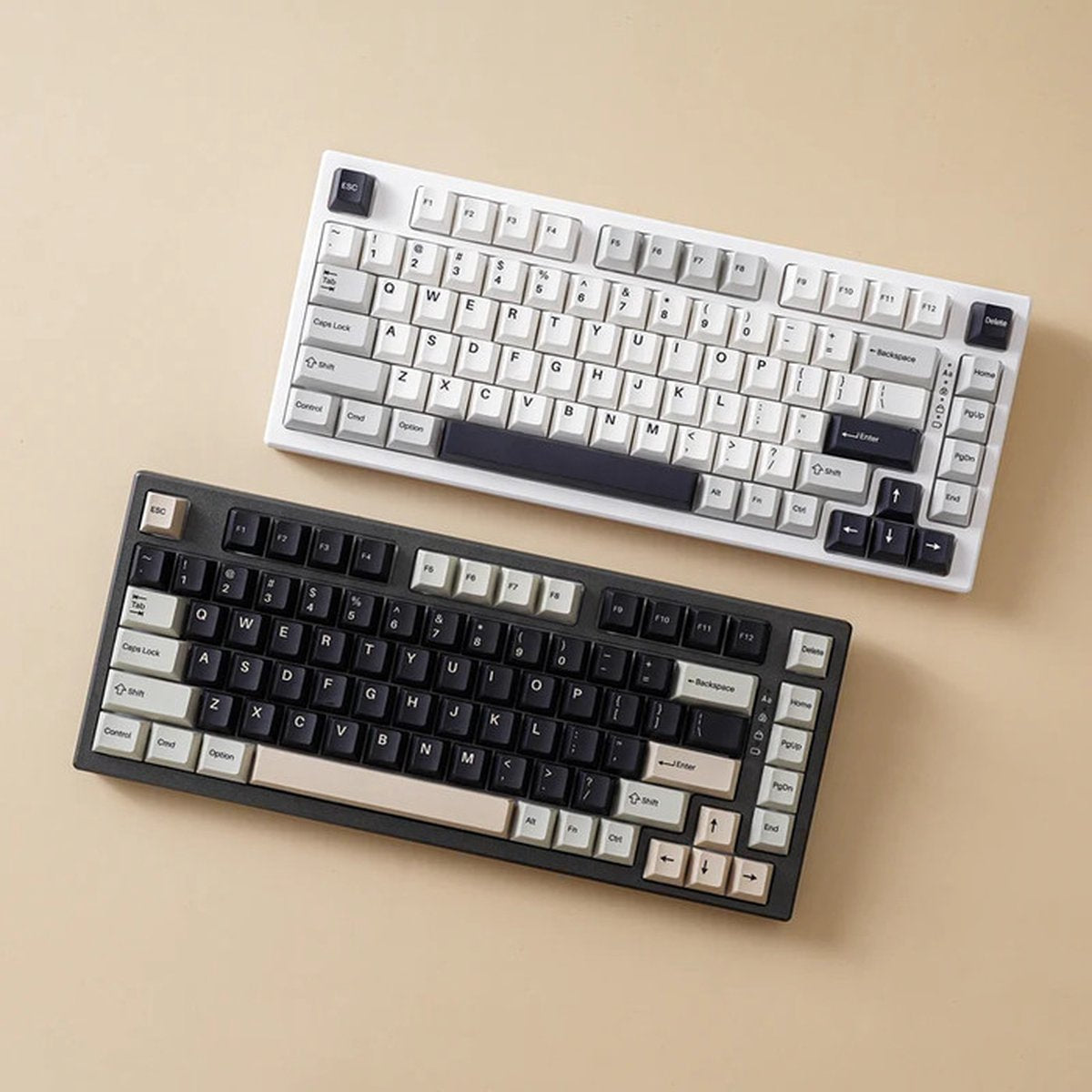 Two mechanical keyboards with keycaps. One white, one black. Keys are labeled with letters, numbers, and symbols. Beige background.