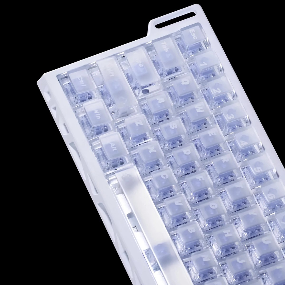 A close-up of a white keyboard with transparent keycaps. Letters and numbers are visible. The background is black.
