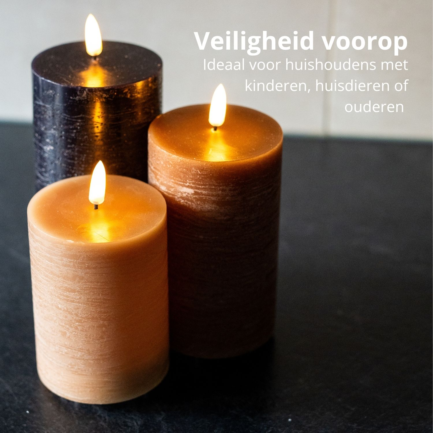 Drie brandende kaarsen, verschillende kleuren, op een donker oppervlak. Nederlandse tekst: Veiligheid voorop, ideaal voor huishoudens met kinderen, huisdieren of ouderen.