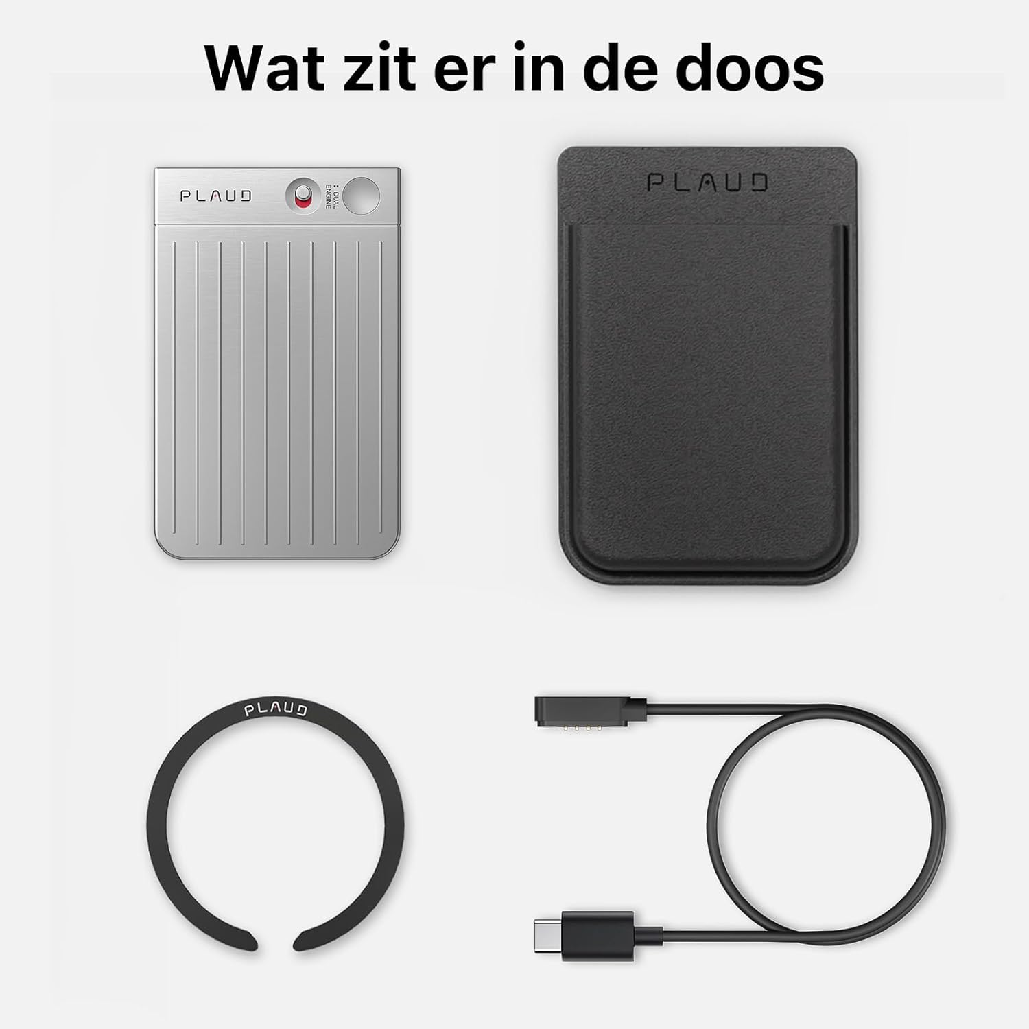 De afbeelding toont een zilverkleurig apparaat, een zwarte hoes, een cirkelvormige ring en een oplaadkabel, alles tegen een witte achtergrond.