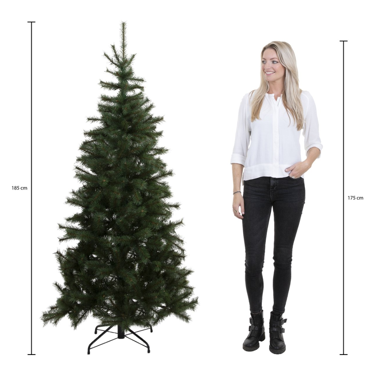 A woman stands beside a green Christmas tree. The tree is 185 cm tall. The woman is 175 cm tall.