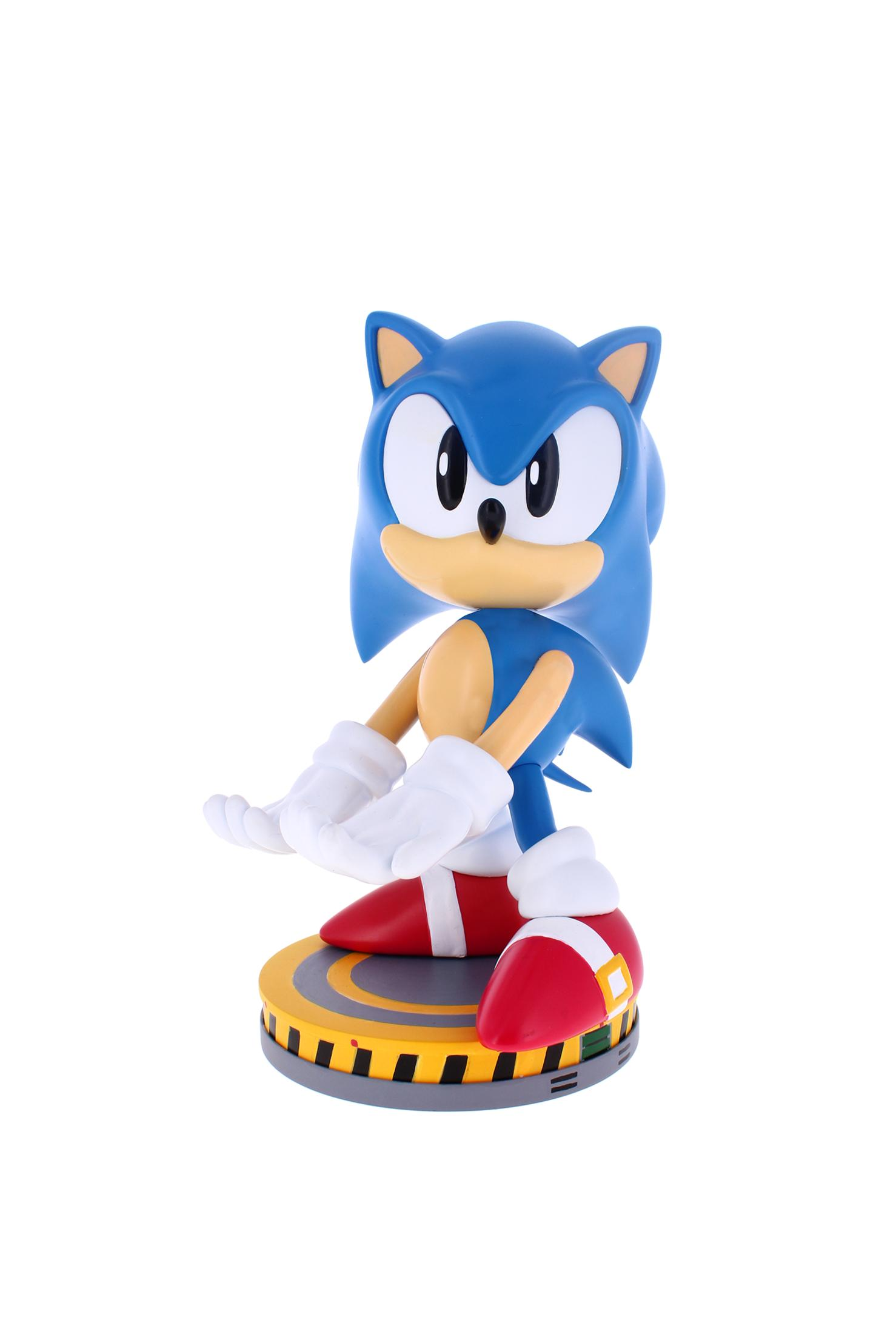 Eine Sonic the Hedgehog-Figur. Sie ist blau mit weißen Handschuhen, roten Schuhen und steht auf einer gelb-schwarzen runden Basis.