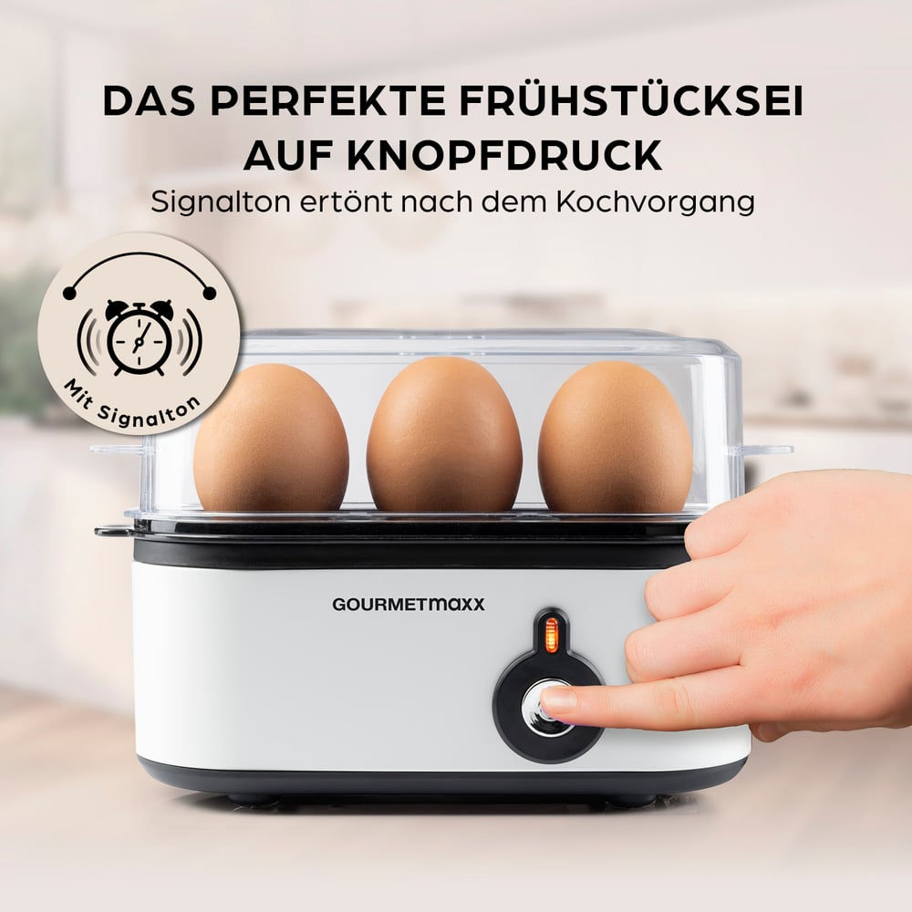 Ein Eierkocher mit drei Eiern. Eine Hand drückt den Ein-Aus-Knopf. Text: Perfektes Frühstücksei auf Knopfdruck.