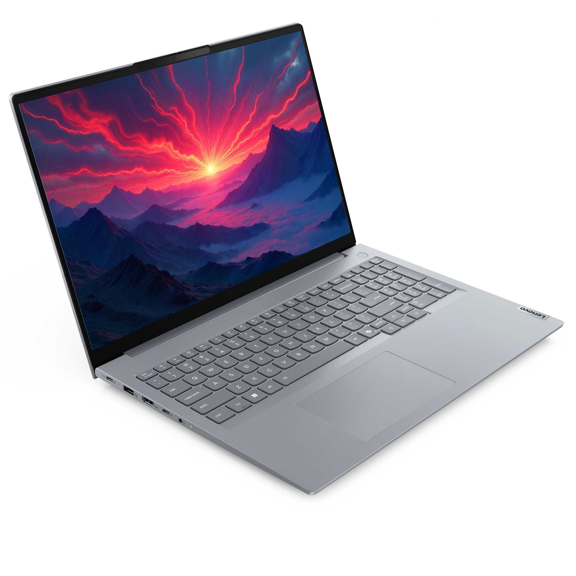 Gri bir Lenovo dizüstü bilgisayar açık. Ekran, dağların üzerinde bir gün batımını gösteriyor. Klavyeyi ve dokunmatik yüzeyi görebilirsiniz.