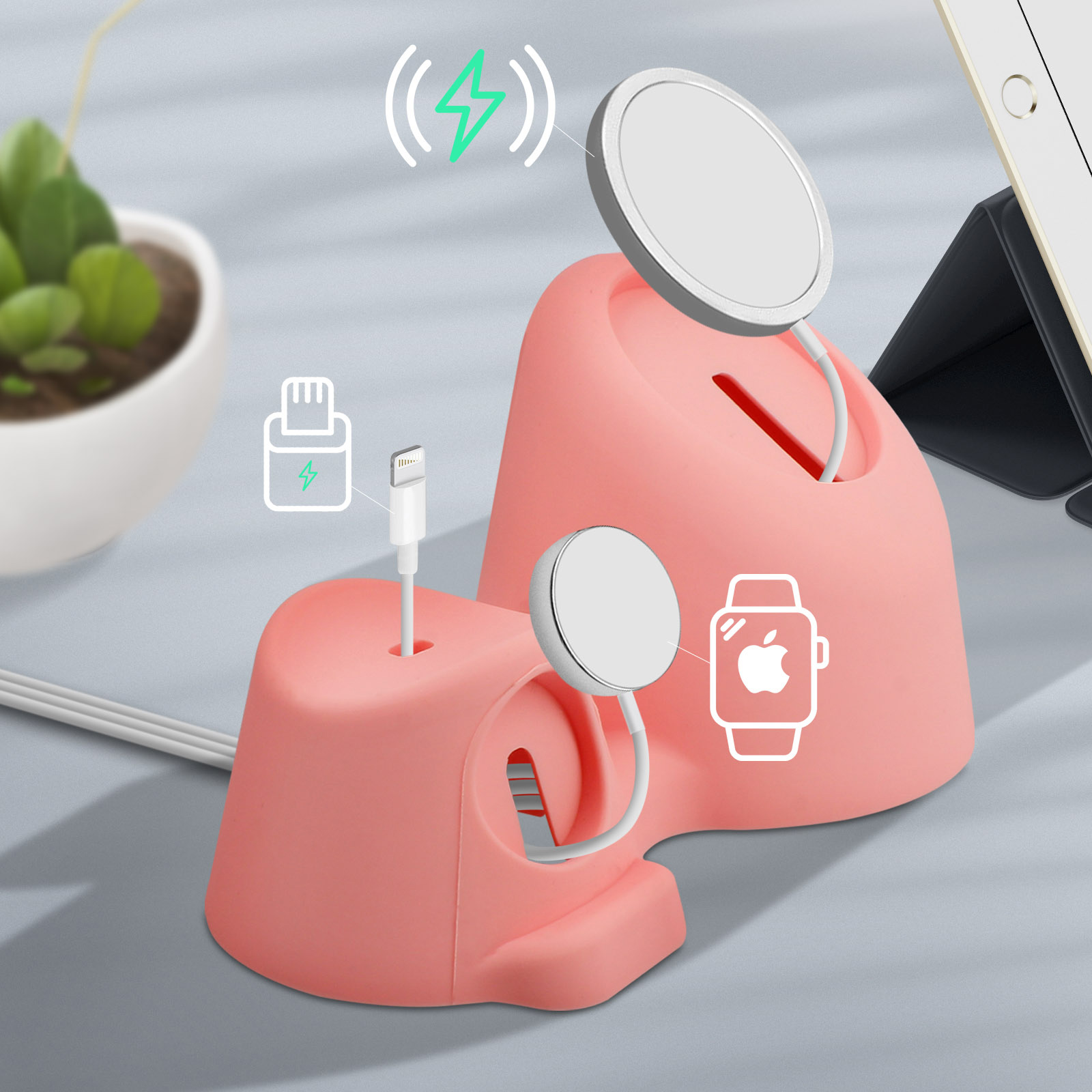 Estación de carga rosa con dos cargadores circulares, un cable Lightning e icono de Apple Watch. Planta y tableta en el fondo.