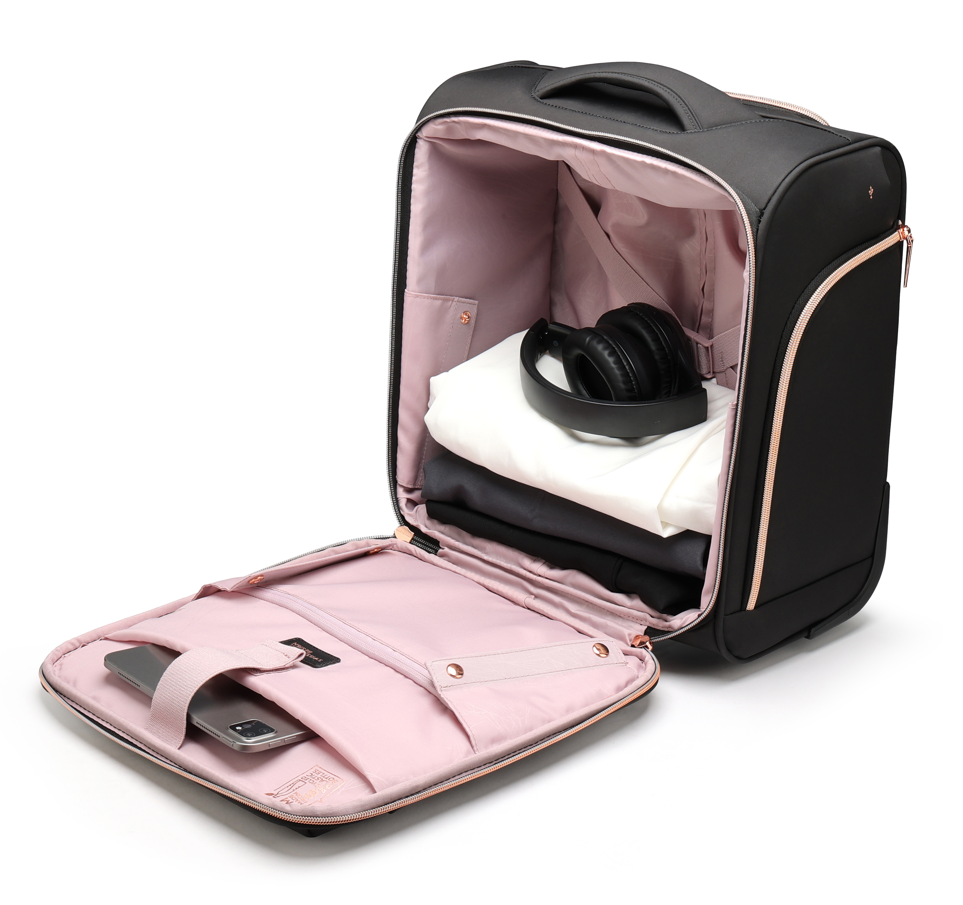 Valigia nera aperta con vestiti, cuffie e telefono. Interno rosa, cerniere oro rosa.