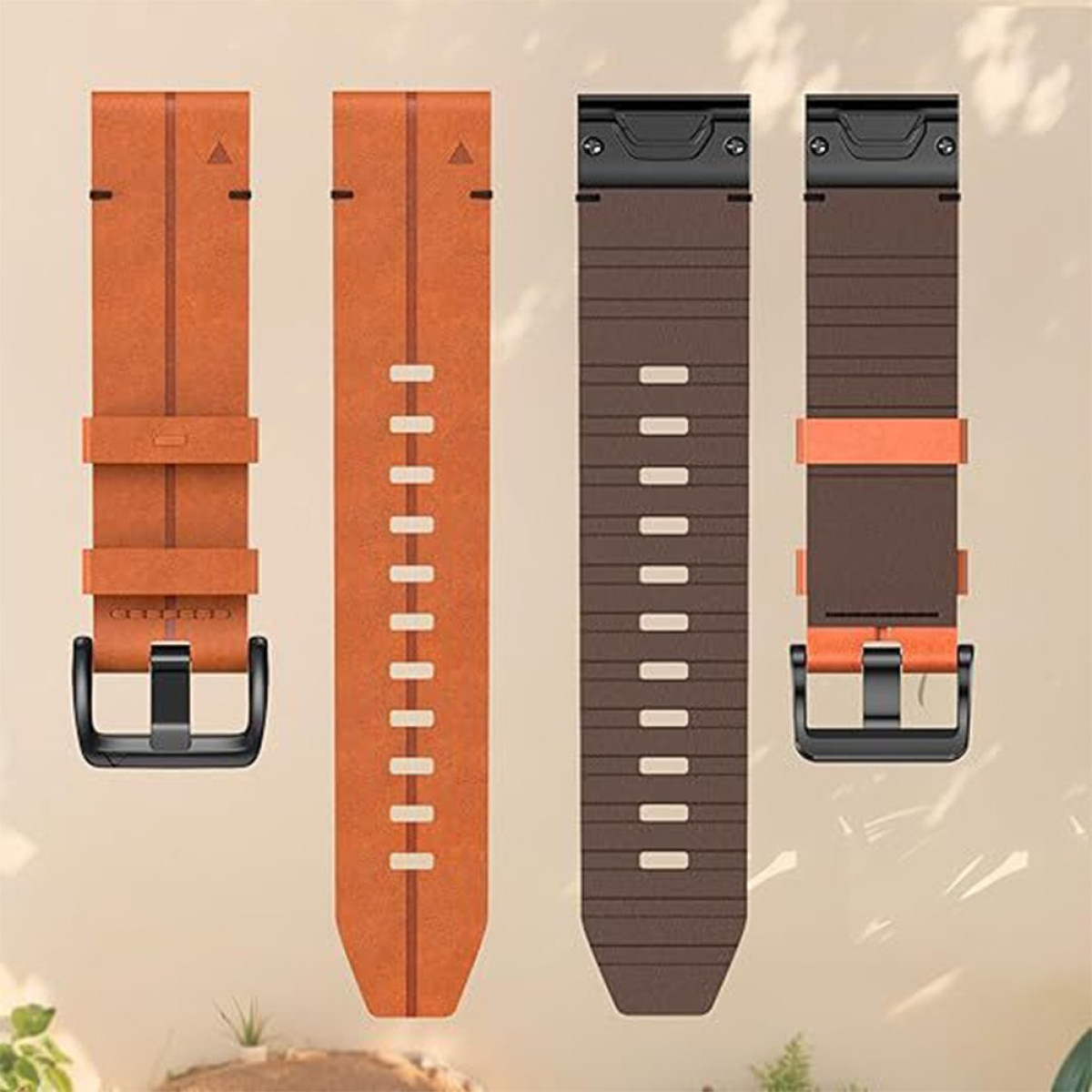 Vier Uhrenarmbänder in Orange und Braun. Sie haben Schnallen und verschiedene Designs. Der Hintergrund ist verschwommen hell.