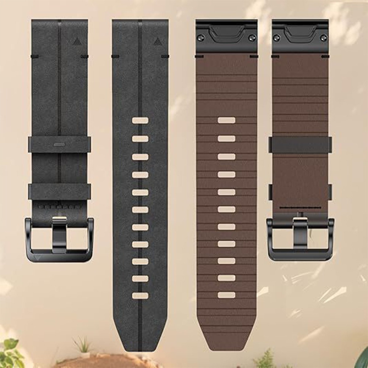 Vier Uhrenarmbänder, zwei schwarze und zwei braune. Jedes Band hat eine Schnalle und Löcher zur Anpassung. Der Hintergrund ist hellbeige.