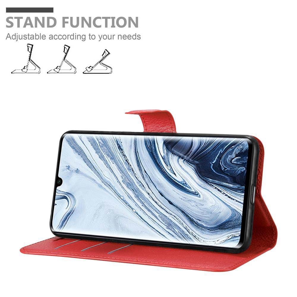 Una custodia rossa con un telefono dentro. La custodia è aperta e ha una funzione di supporto. Testo: 'STAND FUNCTION'.