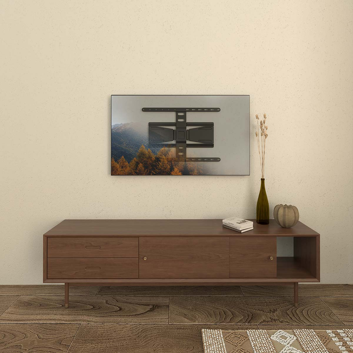 Ein Fernseher mit Berglandschaft ist über einem Holzschrank montiert. Eine Vase, ein Kürbis und ein Buch befinden sich auf dem Schrank.