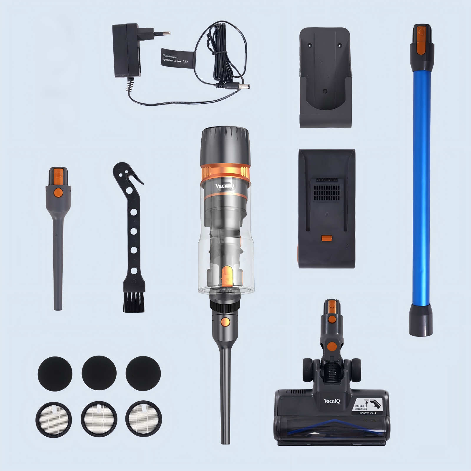 Widok rozłożony odkurzacza pionowego Vacniq. Obejmuje odkurzacz, ładowarkę, filtry i różne akcesoria.