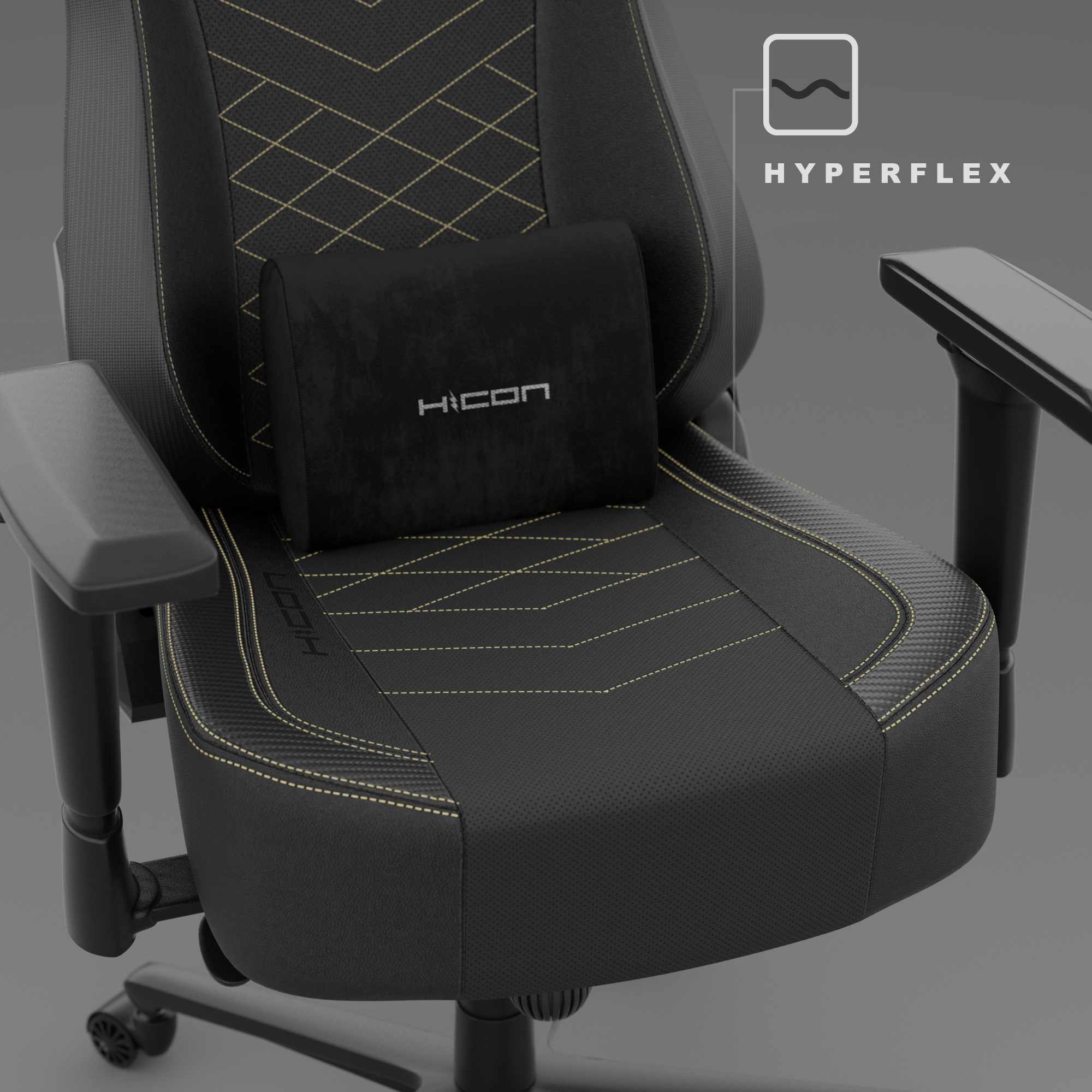 Zwarte en grijze gamingstoel. Zwart hoofdkussen met 'HICON' logo. Gouden stiksels accentueren het ontwerp.