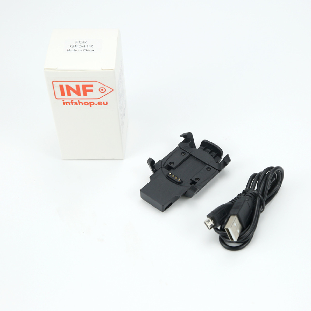 Białe pudełko z logo 'INF', czarna stacja ładująca i kabel USB na białym tle.