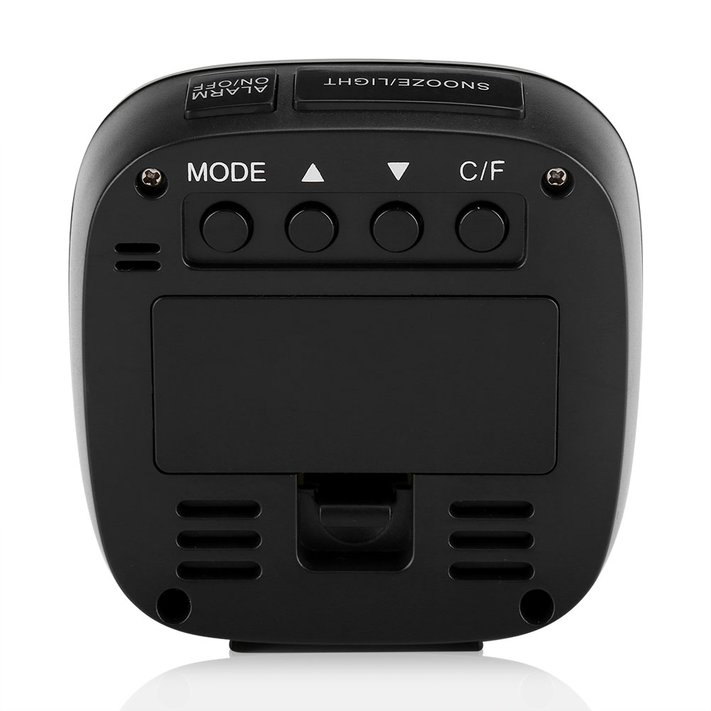 Ein schwarzer digitaler Wecker mit Tasten für Modus, Einstellungen und Alarm. Oben befinden sich Schlummer-/Licht- und Wecker-Ein-/Aus-Tasten.